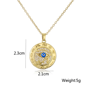 Macro shot of gold Evil Eye pendant with blue stone and size specs 2.3cm by 2.1cm