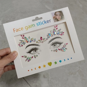 Close-up of holographic face gem stickers in card packaging for music festival makeup
