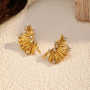 Macro detail of vintage gold geometric coral branch earrings with sparkling crystal rhinestones