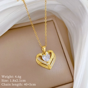 Macro shot of gold heart pendant with crystal inlay and detailed chain measurements