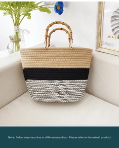 Detail of a color-block woven tote bag featuring natural bamboo handles and textured cotton rope
