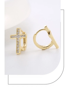 Macro shot of S925 sterling silver stamp and zircon cross earrings in 14K gold