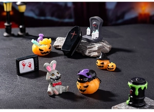 Miniature Halloween figurine set with zombie rabbit, pumpkin and coffin in graveyard scene