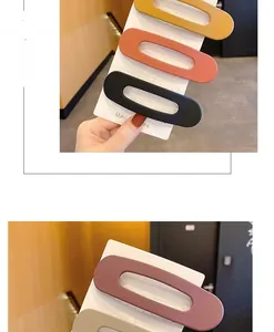 Close-up of matte oval hair clips in assorted colors on cardboard display cards
