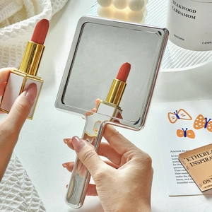 Vintage silver handheld vanity mirror with square frame and minimalist design
