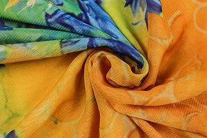Macro view of colorful abstract print fabric with fine mesh texture and soft drapery