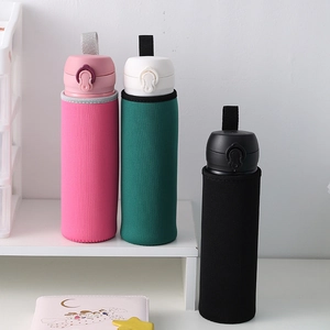 Detailed view of pink, green, and black neoprene insulated sleeve covers for water bottles