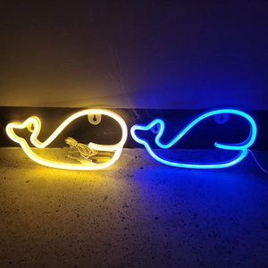 Detailed view of dolphin and whale neon lights showing power cord and battery box
