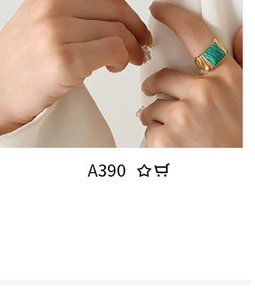 Close-up of a gold adjustable ring with a rectangular green textured stone insert