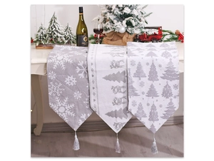 Close-up of knit Christmas table runners with reindeer patterns and fringe details