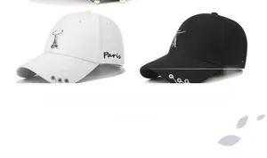 Detail of Paris embroidery and Eiffel Tower pendant on punk style cotton baseball caps