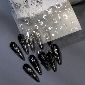 Silver metallic nail art stickers featuring butterfly moon and star patterns on black nails