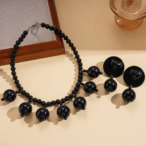 Exaggerated black acrylic beaded necklace and heart earring set with a retro dark style