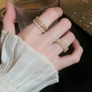 Elegant gold rings featuring hollow pearl edges and square zircon in a luxury style