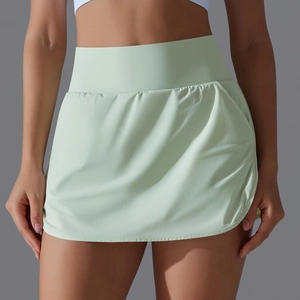Detail view of high-waist mint green tennis skirt with functional side pocket