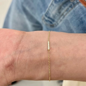 Close-up of minimalist S925 sterling silver thin chain bracelet with tiny diamond bar