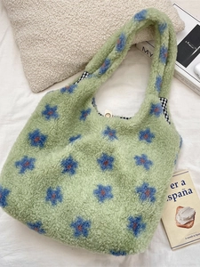 Green plush tote bag with blue star patterns and checkered lining for winter travel