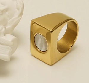 Detail view of 18k gold-plated geometric square ring with white circular shell inlay