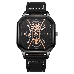 Detail of square black watch with rose gold gears, black leather strap, and white stitching