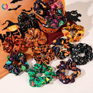 Close-up of Halloween scrunchies with pumpkin and ghost patterns on festive background
