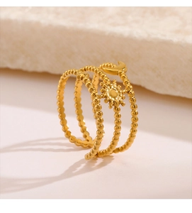 Macro shot of three-layer gold stainless steel ring with sun and moon celestial engraving