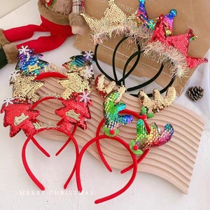 Detailed view of sequined Christmas headbands featuring reindeer antlers and trees