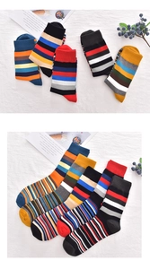 Close-up of colorful striped cotton socks with broad and thin patterns on fabric