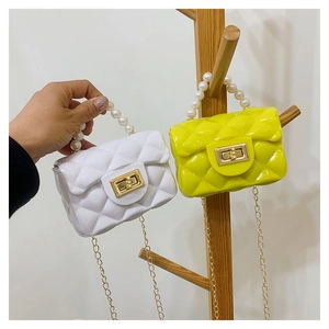 Detail of mini quilted jelly bags with pearl handle and golden chain straps