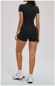 Rear view of black yoga set with open back short sleeve crop top and high waist shorts