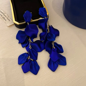 Elegant long tassel earrings featuring blue rose petals on golden chains in a jewelry box