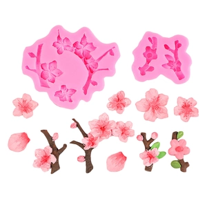 Pink silicone mold for cherry blossom and branch cake decoration on white background