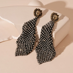 Detail of vintage lion head earrings with black rhinestone fringe on stone pedestals
