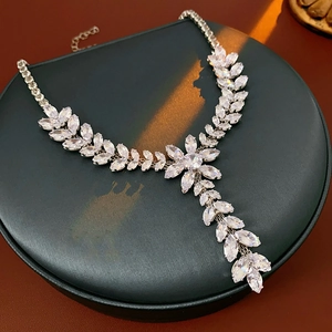 Detailed view of silver wheat ear tassel necklace with sparkling clear zircons on a display pad