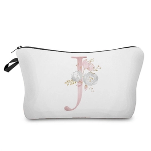 Detailed view of a white makeup bag featuring a pink floral alphabet J print design