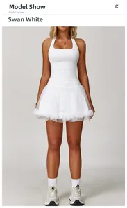 Detail of white cross-back yoga tank top and layered tulle tutu skirt sports set