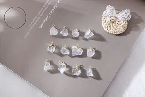 Macro shot of eleven natural clear quartz crystal pendants with elegant gold-plated caps