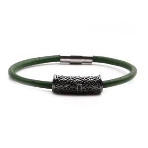 Close-up of green braided leather bracelet with engraved gunmetal beads and magnetic clasp