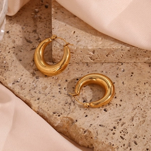 Minimalist 18K gold plated 25mm hollow hoop earrings on marble with pink silk satin