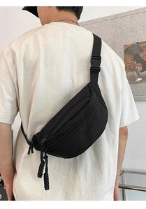 Detail of black waterproof canvas crossbody chest bag with adjustable strap and buckle