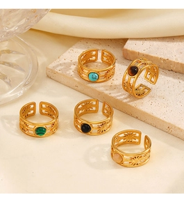 Close-up of gold plated stainless steel rings with colorful gemstones and star cutouts