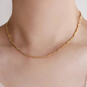 Close-up of 18k gold twisted rope chain necklace worn on neck for luxury jewelry detail