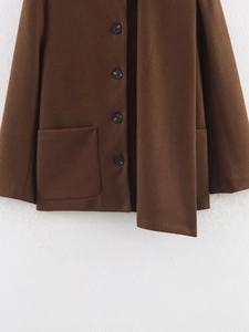 Detail view of dark brown wool coat featuring single-breasted buttons and matching scarf neck