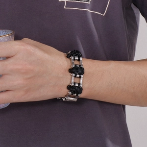 Detail of rock hip hop skeleton skull bike chain bracelet worn on a male wrist