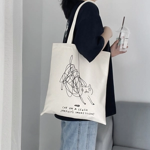 Minimalist beige canvas shoulder bag with artistic black cat graffiti and lettering