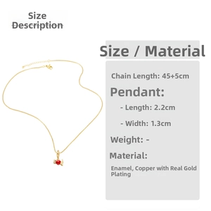 Detailed view of red winged heart pendant on gold chain with dimensions 2.2cm by 1.3cm