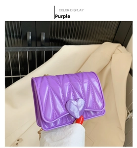 Close-up of purple silicone crossbody bag with wavy texture and large heart buckle