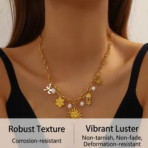 Detail of vintage gold-plated necklace with sun pendants and elegant white pearls