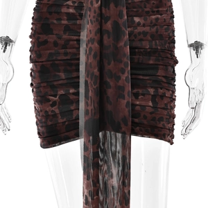 Detail view of leopard print mini dress featuring mesh ruched fabric and a long front tie