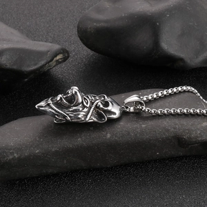 Silver lion head pendant necklace with box chain for men on dark stone surface