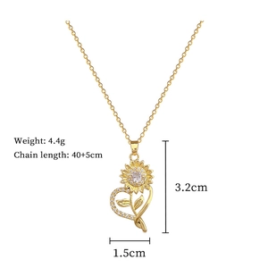 Detail of gold sunflower heart necklace showing dimensions 3.2cm by 1.5cm and 4.4g weight